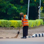 1432590044A-worker-cleans-up-a-road